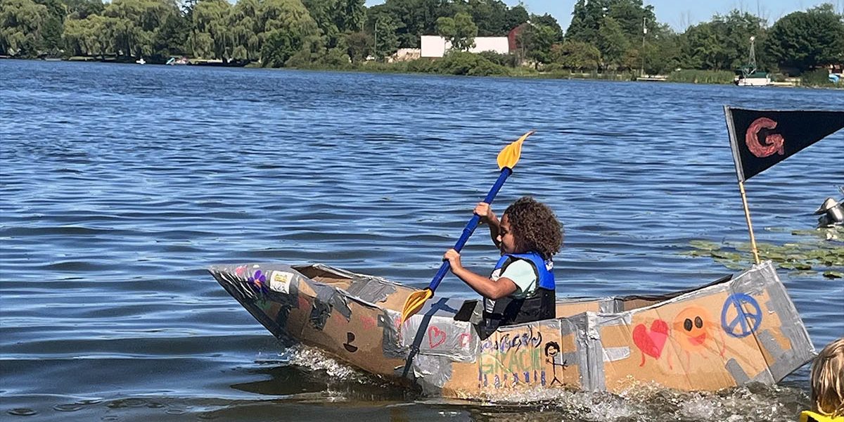 Kids and families enjoying a sunny August lake day at Snow Lake Kampground in Fenwick, Michigan.