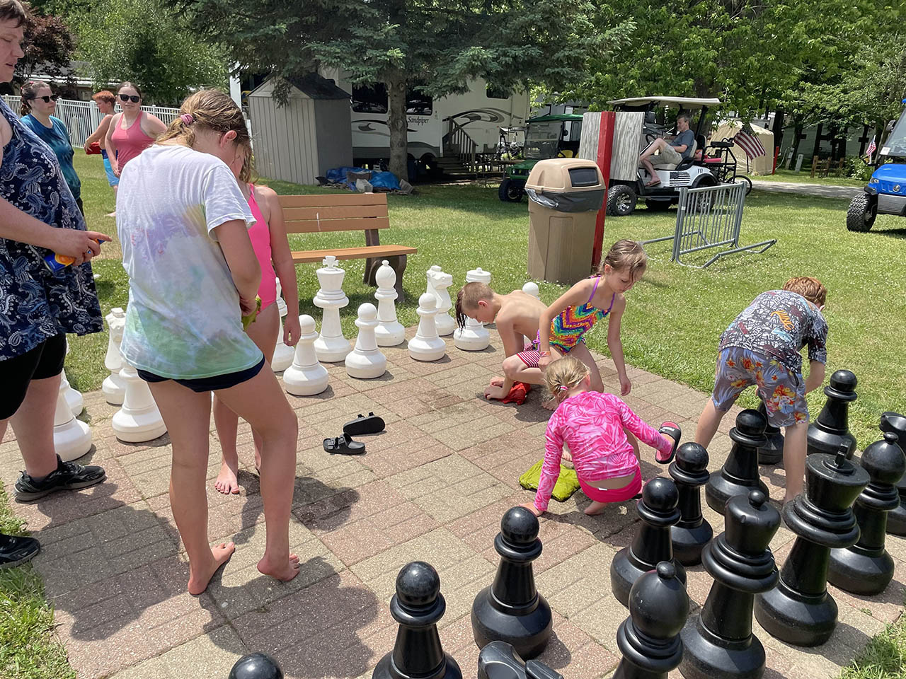 Family enjoying camping activities together at a Michigan campground with kids playing outdoors