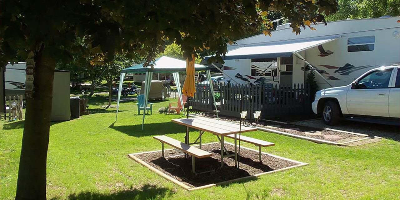 Seasonal RV camping setup near a lake in Michigan with campers enjoying summer